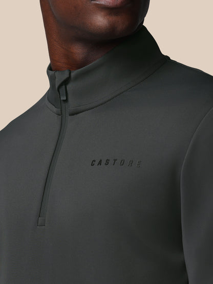 Dark gray half-zip pullover with 'CASTORE' logo on a beige background