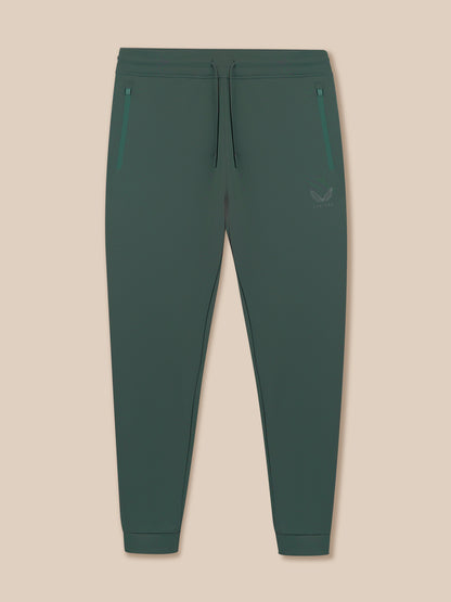 Green jogger pants on a beige background
