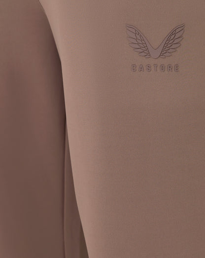 Brown fabric with 'Castore' logo on a matching brown background