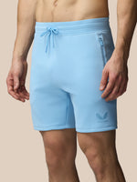 Light blue shorts with a brand logo on a beige background