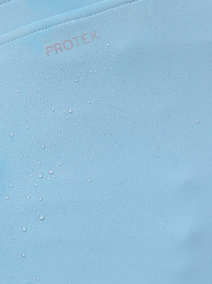 Close-up of a blue fabric with 'PROTEK' branding.
