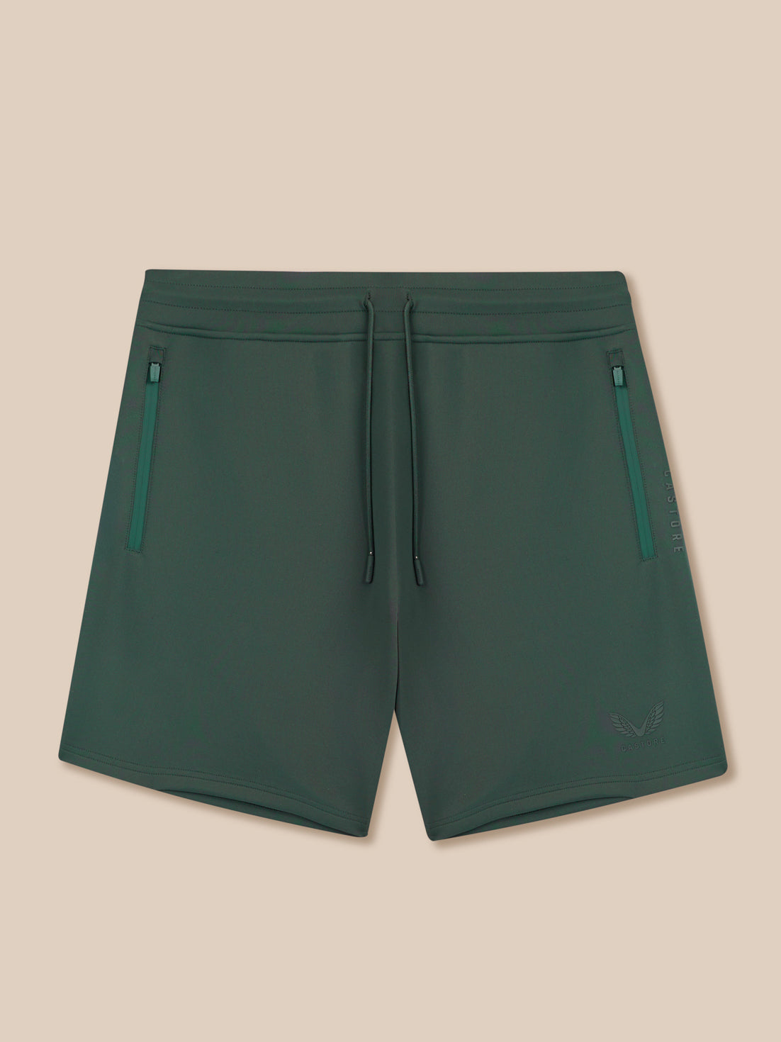 Green shorts with zippers on a beige background