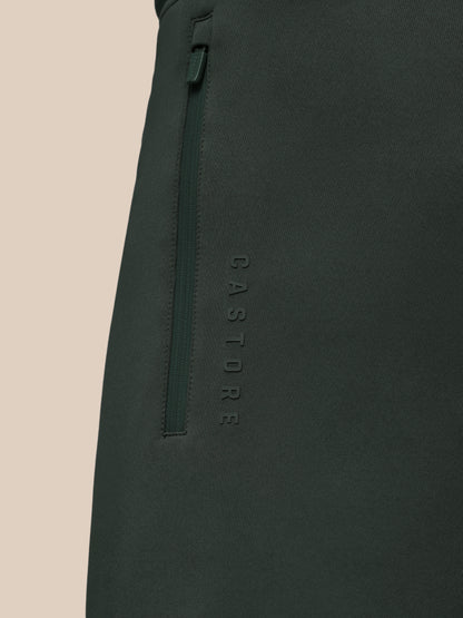 Dark green pants with 'CASTORE' branding on a beige background