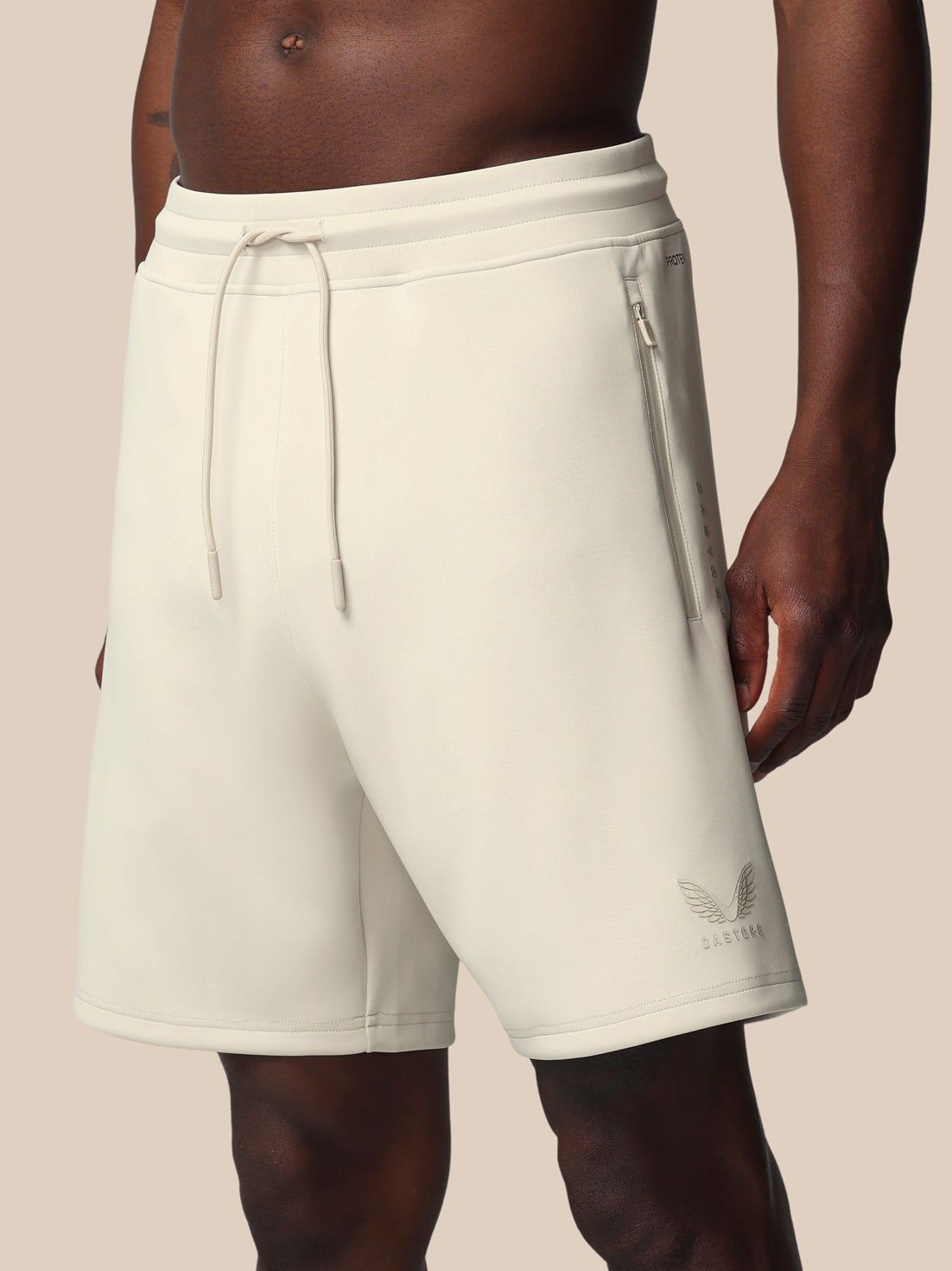 Beige shorts with a brand logo on a neutral background