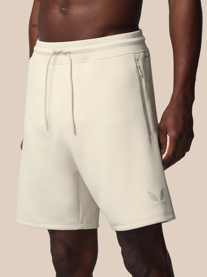 Beige shorts with a brand logo on a neutral background