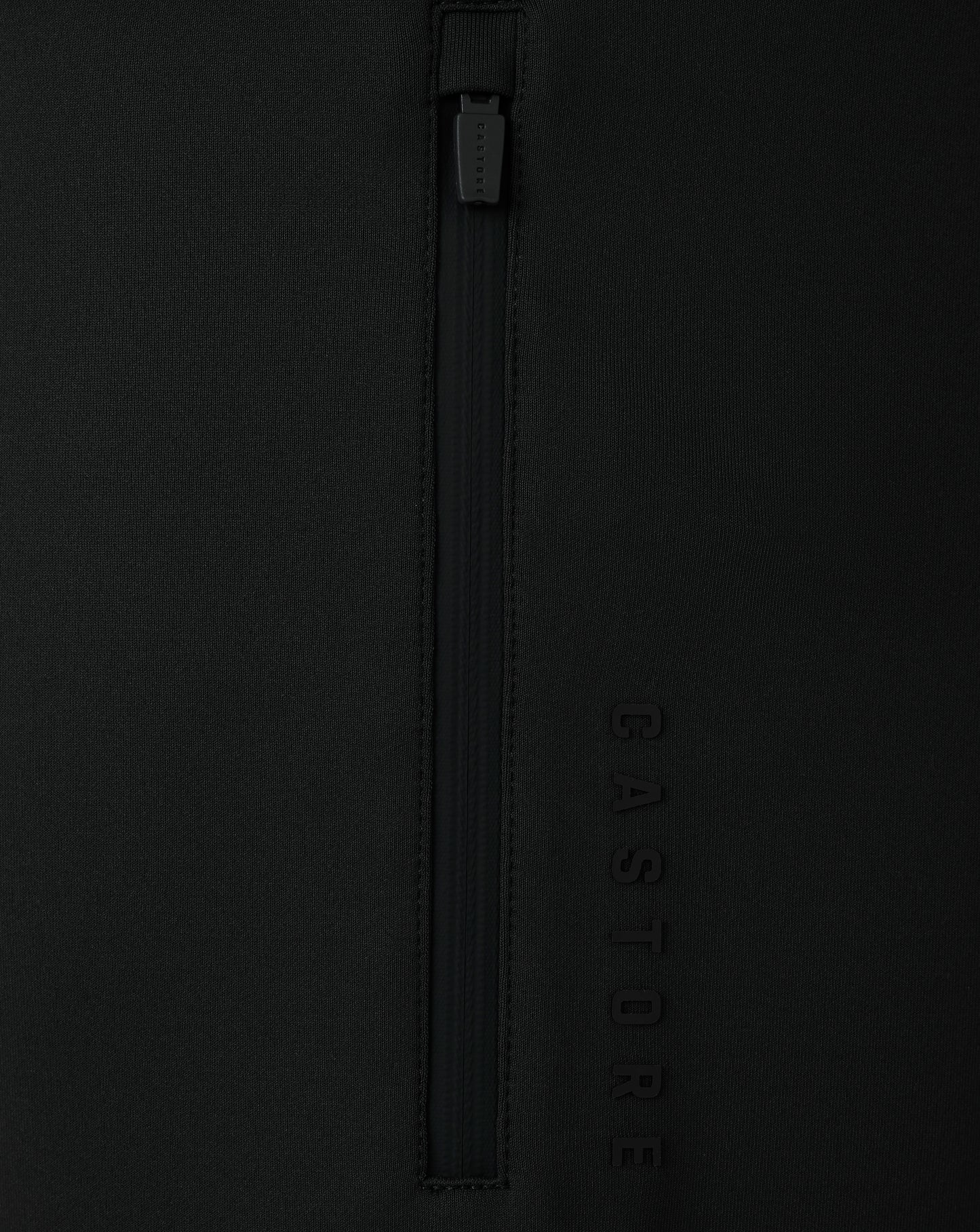 Black jacket with a zipper and 'Castore' branding on a black background