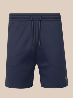 Navy blue athletic shorts with an elastic drawstring waistband, shown against a solid beige background.