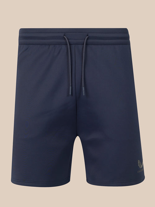 Navy blue athletic shorts with an elastic drawstring waistband, shown against a solid beige background.
