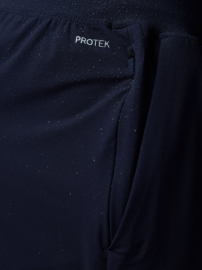 Close-up of a dark blue jacket with 'PROTEK' branding on a black background