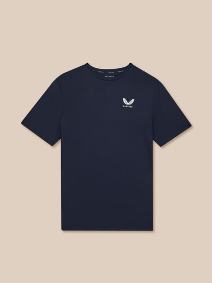 Navy blue t-shirt with a small white logo on a beige background