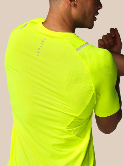 Person wearing a bright yellow athletic shirt with 'Castore' branding.