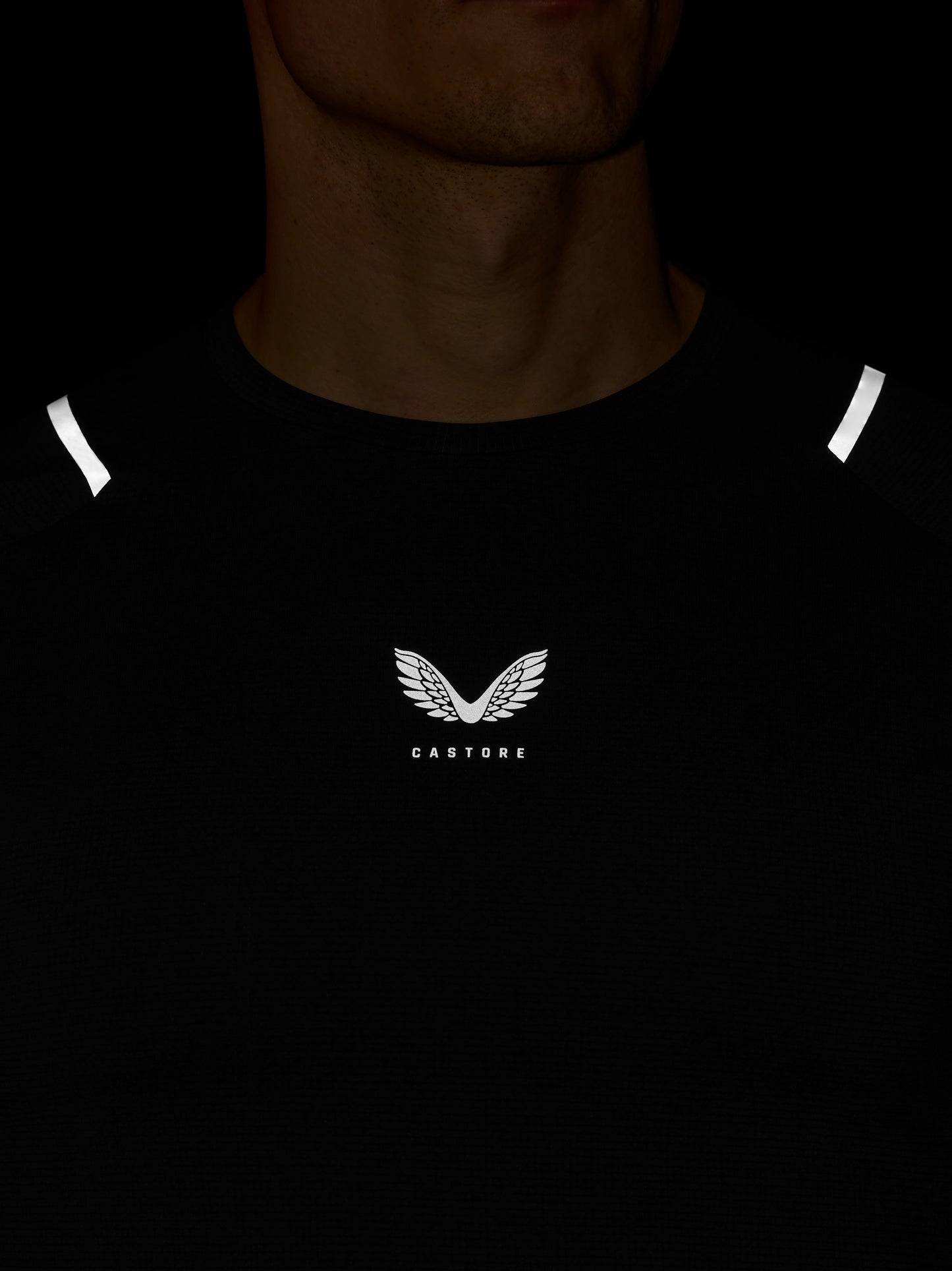 Black t-shirt with a logo and text on a dark background