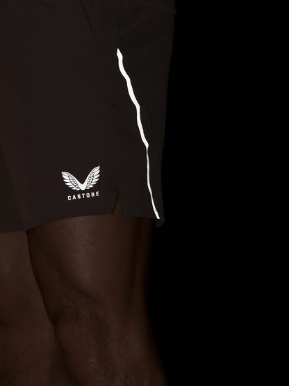 Brown athletic shorts with a white logo on a black background