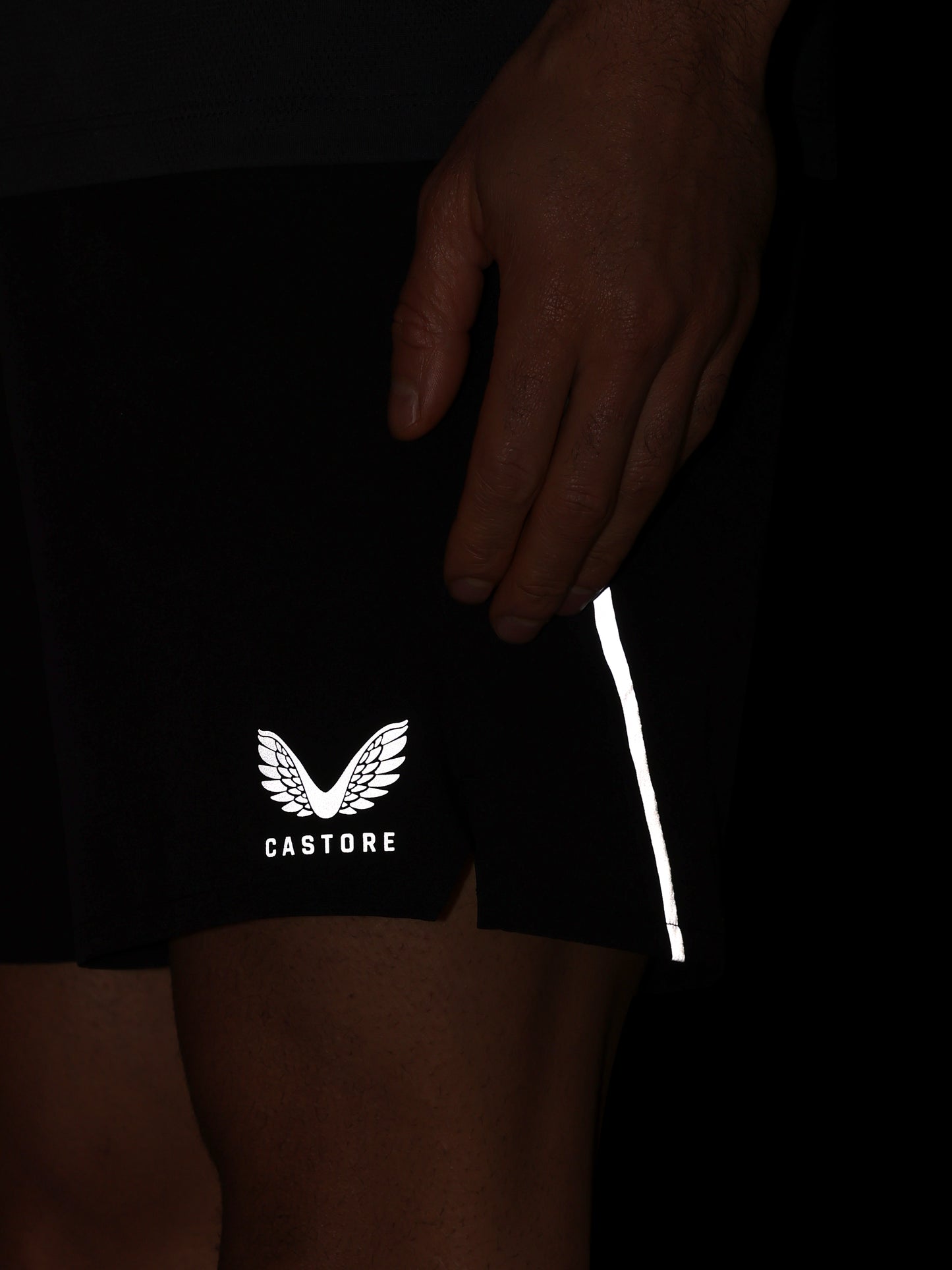 Black shorts with a white logo and text on a dark background
