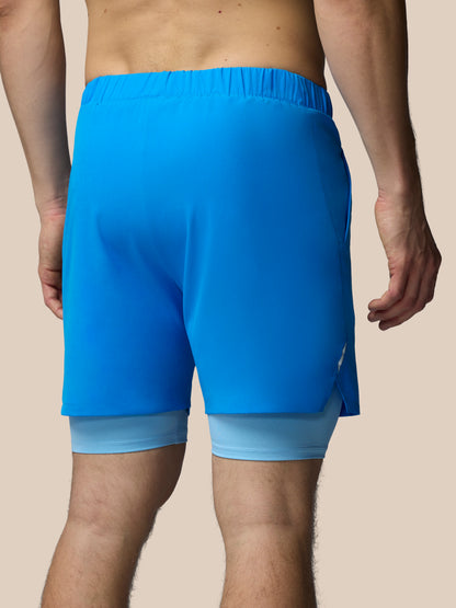 Blue athletic shorts worn by a person on a beige background