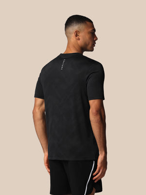 Man wearing a black t-shirt and shorts on a beige background