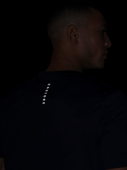 Person wearing a dark shirt with 'CASTORE' branding on the back.