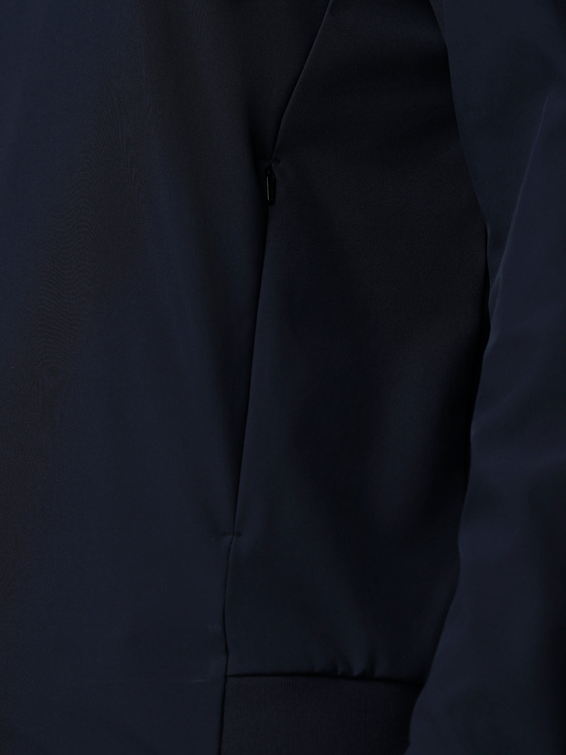 Close-up of a dark gray jacket with a zipper