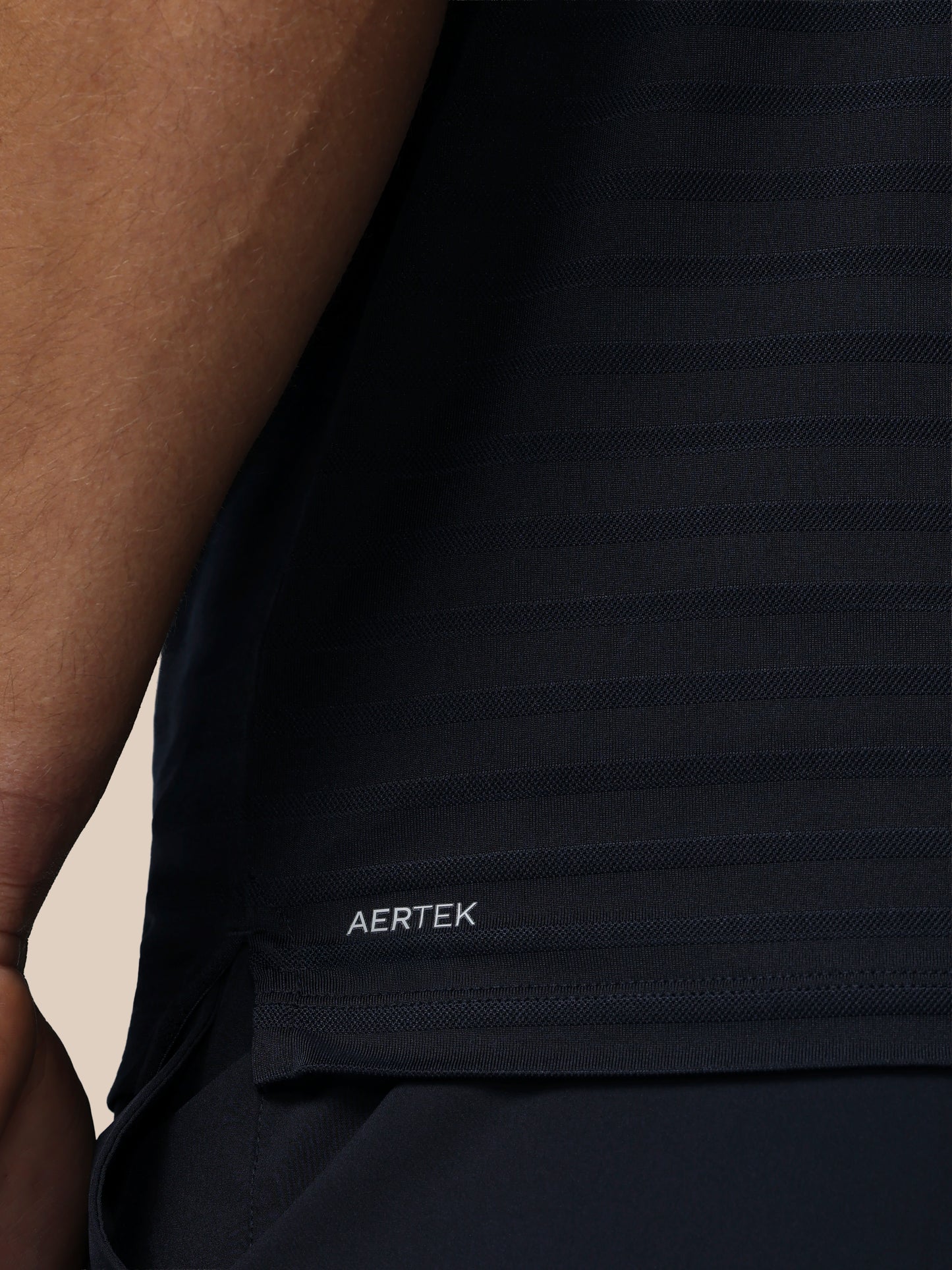 Black sleeveless shirt with 'AERTEK' logo on a person wearing it.