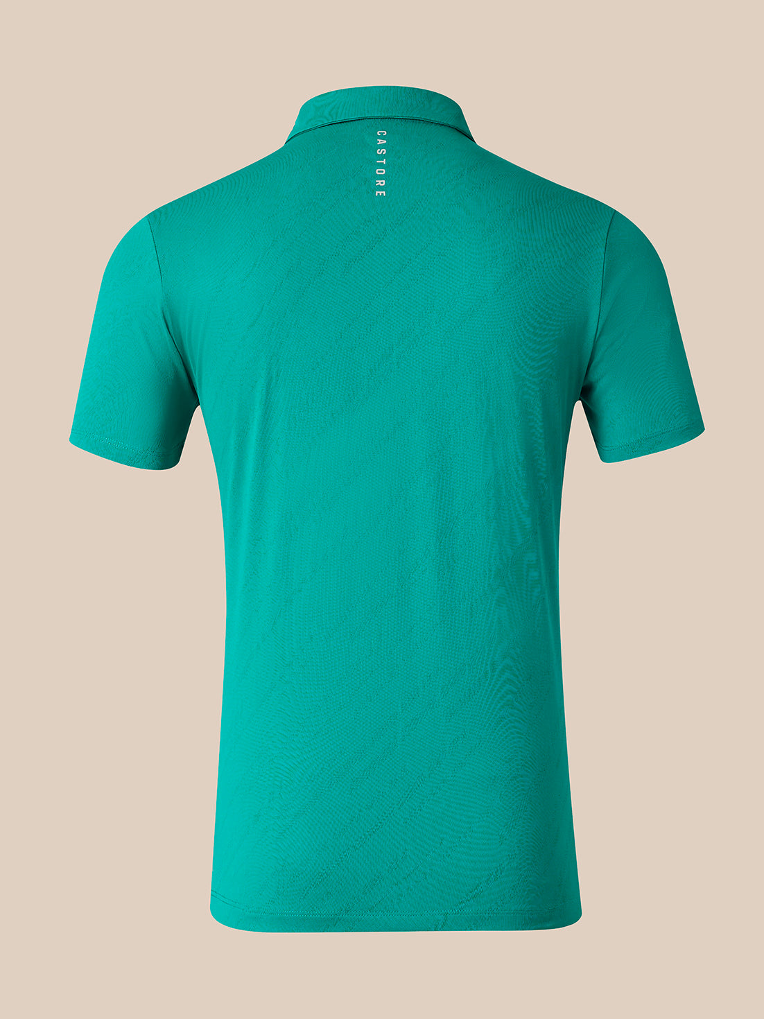 A short-sleeve polo shirt shown from the back, featuring a subtle wavy pattern and a small vertical white 'CASTORE' logo printed at the collar, set against a solid beige background.