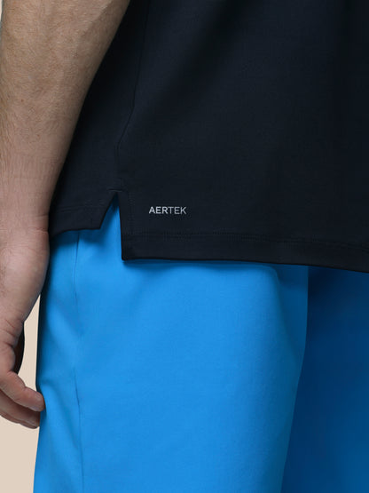 Person wearing a black jacket with 'AERTEK' branding and blue pants.