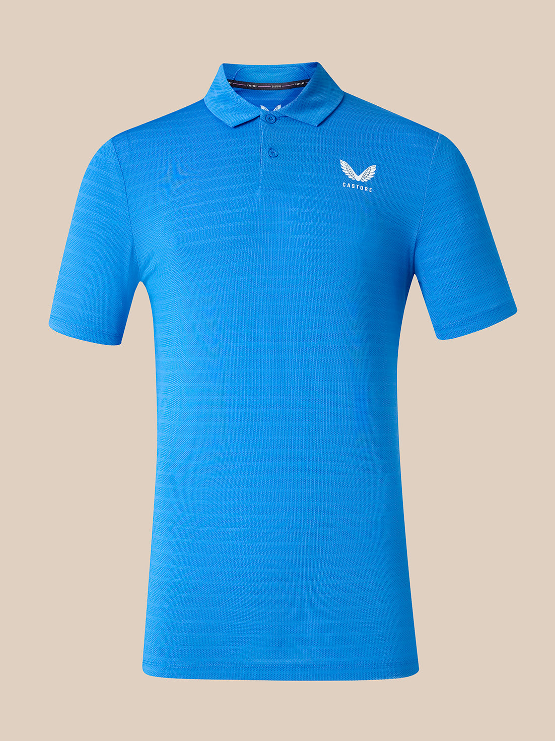 A bright blue short-sleeve polo shirt with a textured knit pattern, featuring a white wing logo and the brand name 'CASTORE' on the left chest, displayed against a solid beige background.