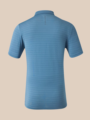 A light blue short-sleeve polo shirt shown from the back, featuring subtle horizontal textured stripes and a small vertical row of buttons at the back collar, set against a solid beige background.