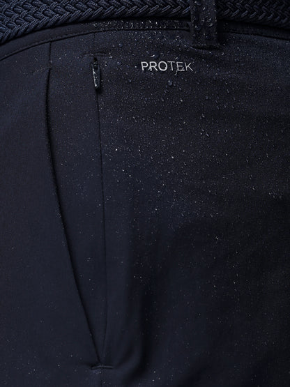 Black pants with a visible 'PROTEK' brand logo on a dark background