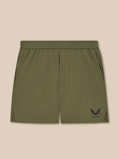 Green shorts with a logo on a beige background