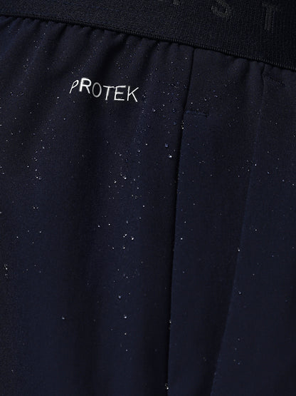 Navy blue fabric with 'PROTEK' branding on a black background