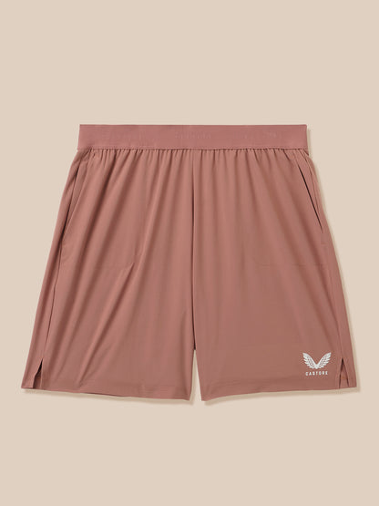 Beige Adapt Training Shorts with pink waistband and Castore logo on lower right leg