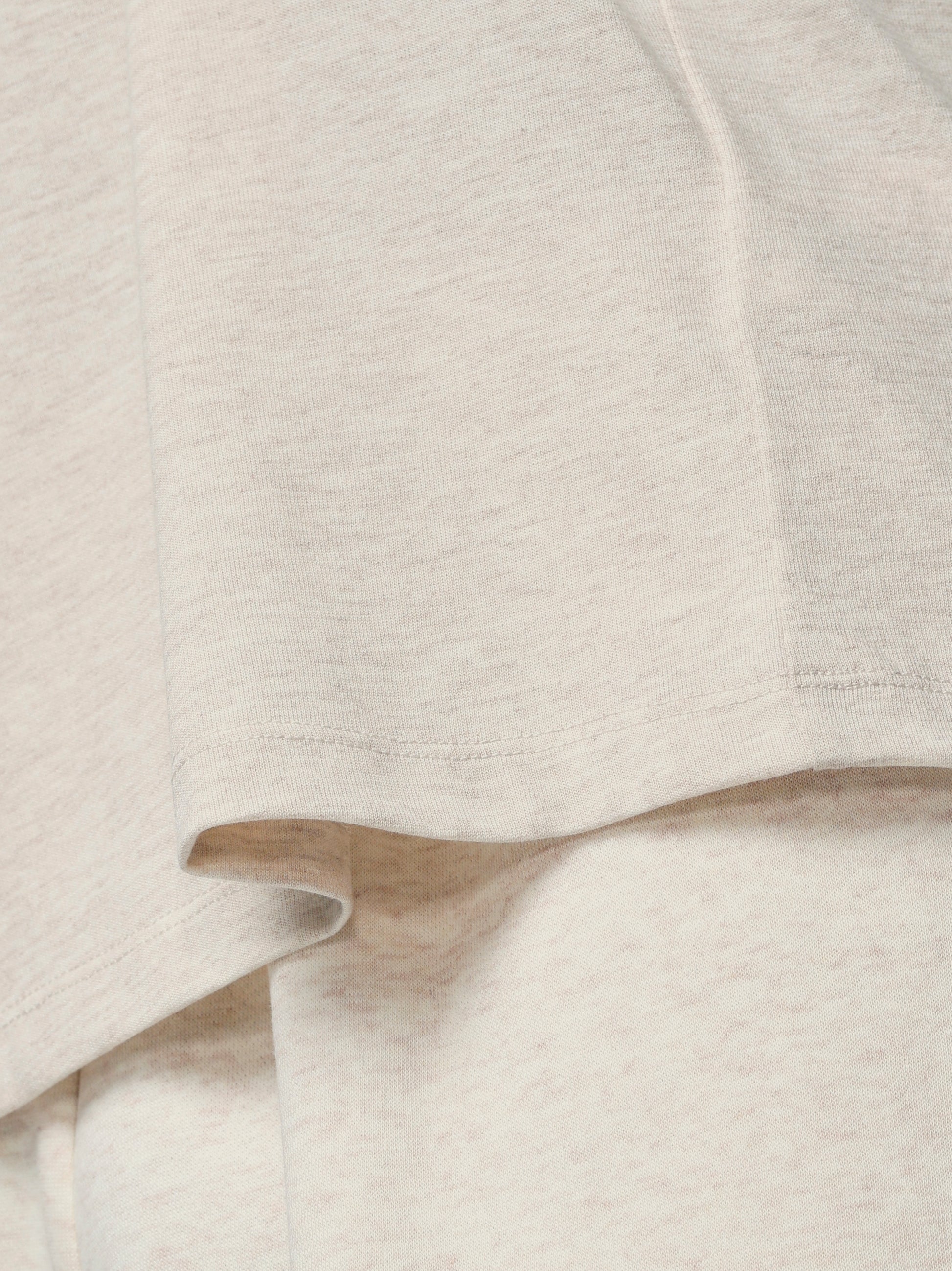 Close-up of a textured beige fabric with a subtle pattern