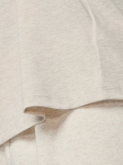 Close-up of a textured beige fabric with a subtle pattern
