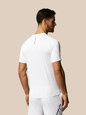 Man wearing a white t-shirt and pants on a beige background