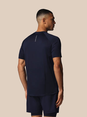 Man wearing a navy blue athletic outfit on a beige background