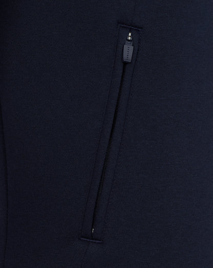Close-up of a navy blue garment with a zipper on a matching background