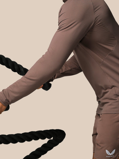 Person using battle ropes in a gym setting