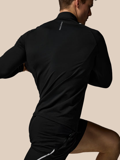 Person wearing a black athletic outfit on a beige background