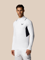 Man wearing a white athletic outfit with a logo on a beige background