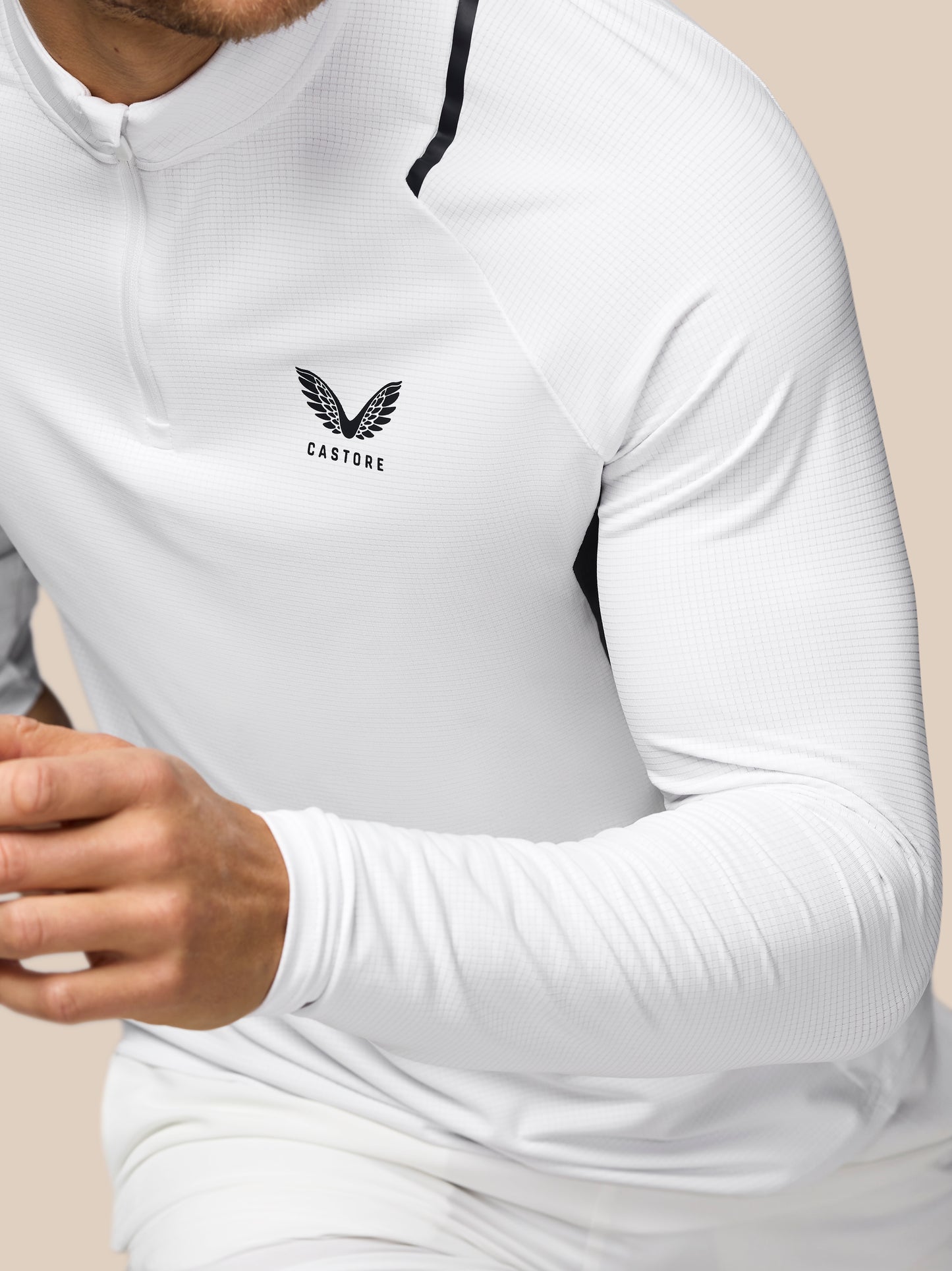 White athletic shirt with a logo on a beige background