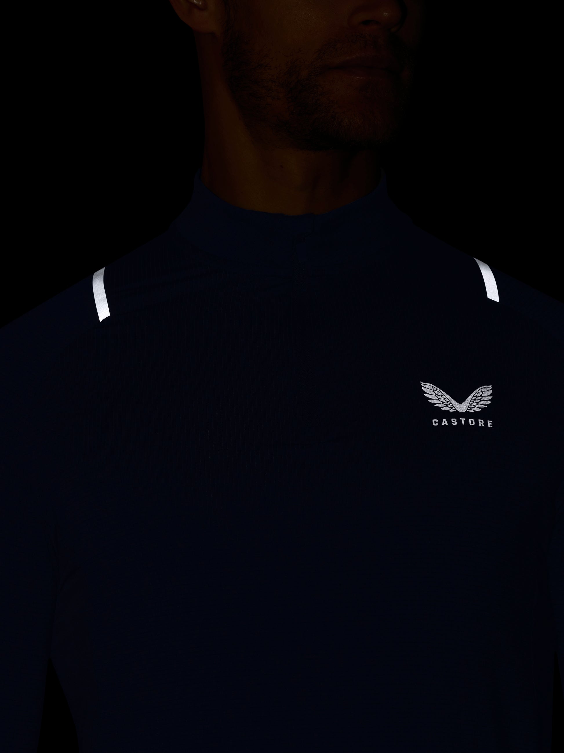 Dark blue athletic shirt with a logo on a black background