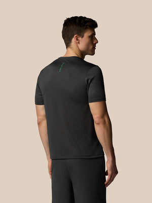 Man wearing a black athletic outfit on a beige background
