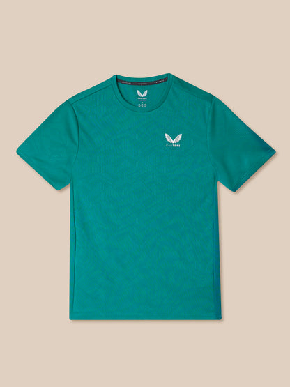 Teal short sleeve performance T shirt with an all over pattern and a small white Castore emblem on the chest