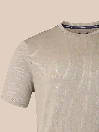A close-up of a short-sleeve crew-neck t-shirt in a light beige or cream color, featuring a subtle vertical textured stripe pattern. The inner collar label shows the brand name 'CASTORE'.