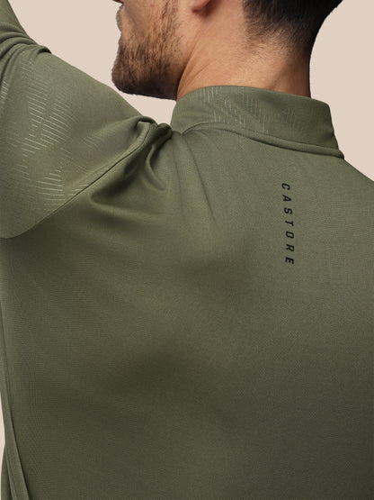 Close-up of a person wearing a green athletic shirt with 'Castore' branding.