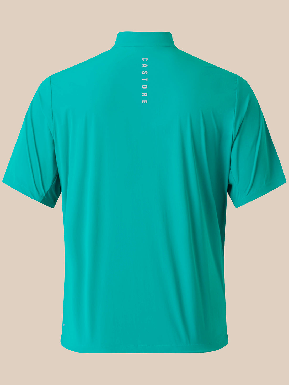 A short-sleeve athletic shirt shown from the back, in a bright turquoise/teal color, featuring the brand name 'CASTORE' printed vertically in white near the collar. The shirt is displayed on a solid beige background.