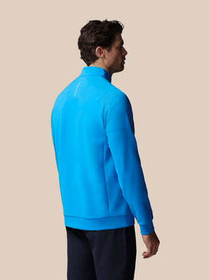 Man wearing a blue jacket on a beige background