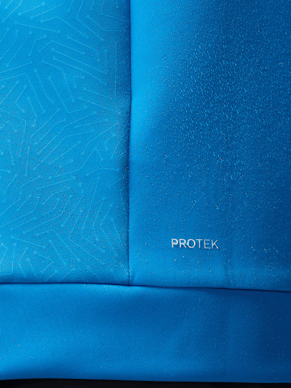 Blue fabric with a subtle pattern and 'PROTEK' branding.