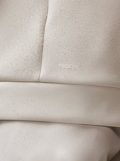 Close-up of beige fabric with 'PROTEK' branding.