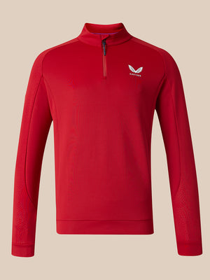 A red long-sleeve quarter-zip athletic pullover with a small white wing logo on the left chest, displayed on a neutral beige background.